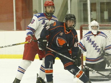 South Grenville defenceman Jacob Montgomery keeps takes on Xavier Brunet of Clarence in front of Rangers goalie Ben Spicer during the first period Saturday night. The game ended in a 3-3 tie.
Tim Ruhnke/The Recorder and Times