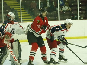 Brockville forward Colin Stacey gets between Cornwall goalie Alex Houston and defenceman Matt Harvey early in the Braves-Colts game at the Brockville Memorial Centre on Friday night.
Tim Ruhnke/The Recorder and Times