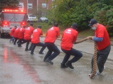 The Brockville Fire Department team crosses the finish line in an impressive time of 30 seconds to take the early lead at the 2021 YMCA George E. Smith Fire Truck Pull on Saturday morning. 
Tim Ruhnke/The Recorder and Times