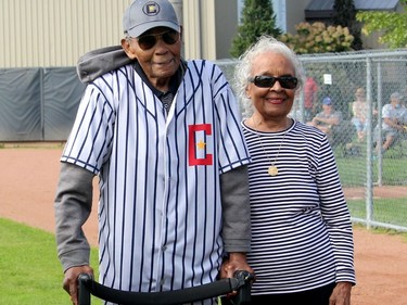 John Olbey, 99, is seen her with his wife of 73 years, Olive, after he received a jersey in honour of his brother Cliff Olbey, who was a member of the 1934 provincial champion Chatham Colored All-Stars baseball team, during a 'Field of Honour' game, feature relatives of team members, played in Chatham on Saturday. Ellwood Shreve/Chatham Daily News/Postmedia Network