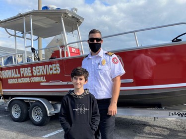 From left, Stefan Marcia standing with our new Deputy Chief Leighton Woods, in fron of Cornwall Fire Services rescue boat on Saturday October 9, 2021 in Cornwall, Ont. Shawna O'Neill/Cornwall Standard-Freeholder/Postmedia Network