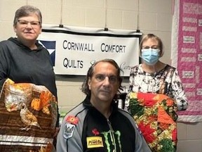 Endurance athlete David Merpaw, with Nicole McIntyre (left) and Mary McDonald of Cornwall Comfort Quilts. Handout/Cornwall Standard-Freeholder/Postmedia Network