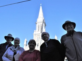 Brian Lynch, Anne Gauthier, Kelly Poitras, Fr. Thomas Riopelle and Pat Vincelli stand proudly in front of the St. Columban Church's new cross, on Wednesday October 20, 2021 in Cornwall, Ont. Francis Racine/Cornwall Standard-Freeholder/Postmedia Network