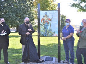 From left to right, Father Adam Brown, Archdeacon Peter Crosby, president of the United Empire Loyalists Association of Canada Patricia Groom UE and Cornwall Coun. Claude McIntosh moments after revealing the new plaque recognizing local John Baker on Wednesday October 20, 2021 in Cornwall, Ont. Shawna O'Neill/Cornwall Standard-Freeholder/Postmedia Network