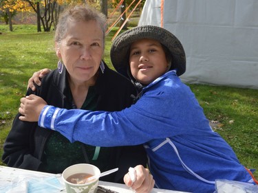 Native North American Training College manager Iakonikonriiosta with her grandson Kanonkwatsherake James Jocko-Skidders enjoying some lunch on Saturday October 23, 2021 in Kawehno:ke. Shawna O'Neill/Cornwall Standard-Freeholder/Postmedia Network