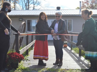 From left, Maie Thomas, Theresa 'Bear' Fox, Marjorie Skidders and Iakonikonriiosta cutting the ribbon to the updated Native North American Training College during its grand reopening on Saturday October 23, 2021 in Kawehno:ke. Shawna O'Neill/Cornwall Standard-Freeholder/Postmedia Network