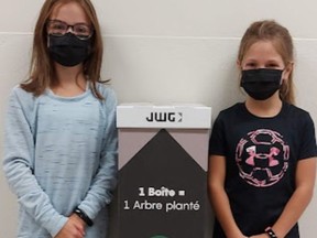 Two CSDCEO students posing with one of the many mask recycling boxes installed in the school board's schools. Handout/Cornwall Standard-Freeholder/Postmedia Network