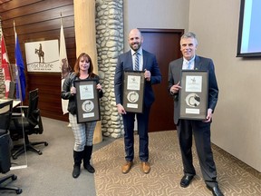 Councillors Marni Fedeyko, Patrick Wilson and Alex Reed at their October 25 inauguration ceremony with plaques featuring the original Cochrane Ranche brand. Patrick Gibson/Cochrane Times