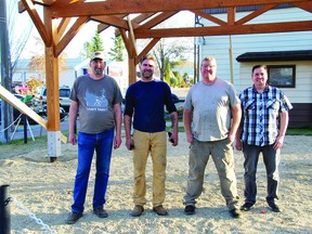 (L-r) Devon Legion president and volunteer Stanley Abma, Heritage Timber Frames president Trevor Johnson, timber framer and site foreman Dean Martens and the Devon Legion project leader and second vice president Adrian Sewepegaham. (Supplied by Devon Legion)