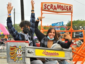 Many were happy to see the fall fair tradition return to the Norfolk County Fairgrounds Tuesday for another Young Canada Day at the Norfolk County Fair. Thrilled to renew acquaintances with The Scrambler on NCF’s popular midway were Ricardo Saroop of Selkirk and Miley Lopes of Simcoe. – Monte Sonnenberg