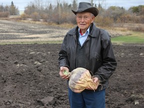 Cliff Knull shows off the 15-pound turnip he harvested from his garden this fall. (Ted Murphy)