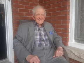 Peter Davy, sitting outside his Odessa-area house, turns 90 in October. He is Kingston's oldest active real estate agent.