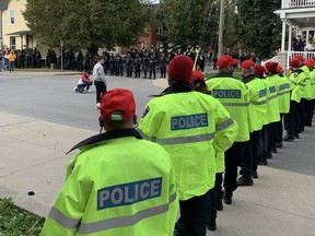 Large numbers of police officers block access to Earl Street and Aberdeen Street in Kingston during unsanctioned Homecoming gatherings on Oct. 23.