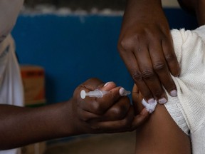 A nurse injects a patient with their second dose of AstraZeneca vaccine on Sept. 29, 2021, in Kampala, Uganda. Many countries have faced criticism after offering their citizens a third booster jab while less than four per cent of Africa's population has had a second dose.