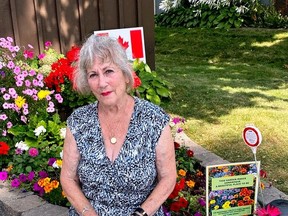 Alison Evans of 455 Charles Street with her beautiful, raised flower bed, one of more than 20 winners of the Gananoque Horticultural SocietyÕs annual Curb Appeal Awards.  Supplied by Joan MacKinnon