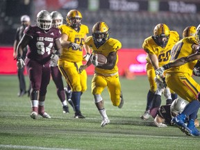 Queen's Gaels running back Rasheed Tucker runs for yardage against the Ottawa Gee-Gees in Ontario University Athletics football action at TD Place in Ottawa on Thursday. Queen's won the game, 30-12, to cap a 6-0 undefeated regular season.