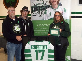 The Lucan Irish hosted the 'Nick Smith Memorial Game' Oct. 16 at the Lucan Community Memorial Centre to pay tribute to the former Irish player and to retire his jersey, #17. Smith passed away Oct. 6, 2019. Pictured are his parents Dave and Denise and his brother Eric. Smith's jersey will hang in the arena foyer.