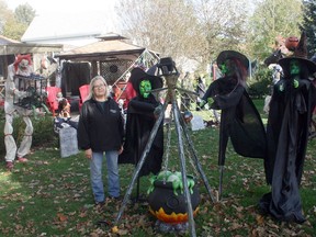 Barb Jeffrey stands among the Halloween items that she and her boyfriend Marty Isaac have decorated their John Street North home in Zurich with. Jeffrey said the display gets bigger every year. Scott Nixon