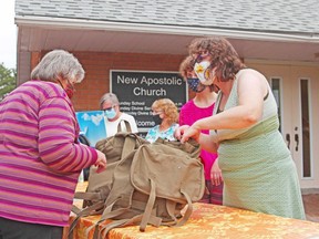 Rebecca Riesen, right, receives a donation at the New Apostolic Church in June as part of the Backpacks of Love campaign organized by the Compassionate Committee for the Homeless in North Bay. Nugget File Photo