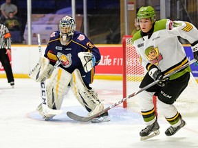 Liam Arnsby, freshly minted captain of the North Bay Battalion, seeks out the puck in the Barrie Colts' zone in front of goaltender Jet Greaves in a game during the 2019-20 Ontario Hockey League season. Submitted Photo