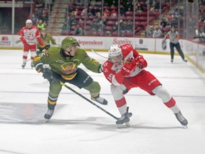 Tnias Mathurin of the North Bay Battalion and Bryce McConnell-Barker of the Soo Greyhounds compete in Ontario Hockey League action, Friday night, at GFL Memorial Gardens. Gordon Anderson/Sault Star