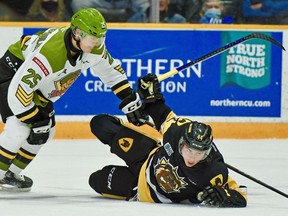 Alex Christopoulos of the North Bay Battalion deals with Nathan Staios of the Hamilton Bulldogs in first-period Ontario Hockey League action, Thursday night. The Troops completed a four-game home stand. Sean Ryan Photo