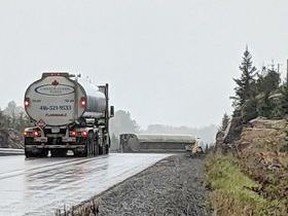 A commercial motor-vehicle is seen on its side, Thursday, on Highway 11 in Powassan following a single collision. Ministry of Environment is investigating the spill of diesel and gasoline. Jessica Ballan Photo