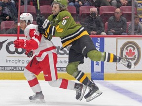 Josh Currie of the North Bay Battalion and Marco Mignosa of the Soo Greyhounds compete in first-period action, Friday night, at GFL Memorial Gardens. Gordon Anderson/The Sault Star