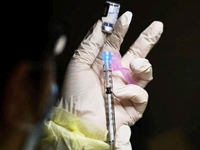 A registered pharmacist technician fills the Pfizer-BioNTech COVID-19 mRNA vaccine at a vaccine clinic during the COVID-19 pandemic. (file photo)