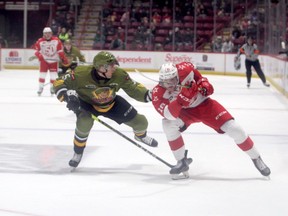 North Bay Battalion defenceman Tnias Mathurian (left) and Soo Greyhounds forward Landen Hookey battle for the puck during Ontario Hockey League action at the GFL Memorial Gardens on Friday.  The Greyhounds opened up the season with a 4-1 win over the Battalion. The ‘Hounds are back in action on Saturday night, a 7:07 p.m. puck drop against the visiting Sudbury Wolves.