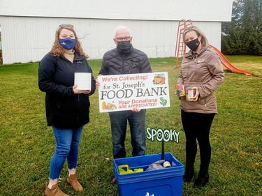 Monetary and food donations were collected for the St. Joseph's Food Bank during the second annual Spooky Movie Night at the Skylight Drive-in in Laurentian Valley on Oct. 16. Approximately $770 dollars and non-perishable food items were collected that evening. Taking part in the presentation of cash and food items (from left) were Sarah Frederick, recreation programmer City of Pembroke; John Kilborn, St. Joseph's Food Bank and Navada Sargent, planning and recreation co-ordinator Township of Laurentian Valley.