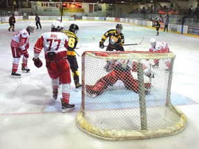 Photo by KEVIN McSHEFFREY/THE STANDARDElliot Lake Red Wings goaltender Ryder Gregga made the save against this shot fired by a Soo Michigan Eagles player on Saturday evening at the Centennial Arena. The Red Wings were defeated 8-3. For the story, see page 9