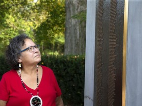Chippewas of the Thames Director of Language and Culture Gina McGahey looks at some of the hundreds of names of former students on the Mount Elgin Industrial Residential School Monument in Muncey. Derek Ruttan/Postmedia Network