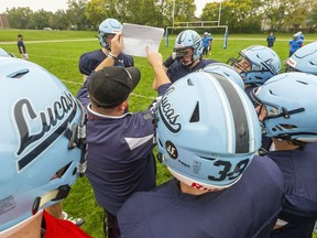 Lucas' offensive co-ordinator Gary Gerard lays out the play for the Lucas offence during practice at A.B. Lucas Secondary School in London on Oct. 4. MIke Hensen/Postmedia Network