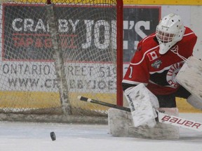 Listowel Cyclones' goalie Carter Garvie finds a loose puck during the team's game in Stratford this season.