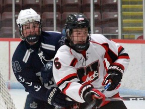 Woodstock’s Griffin Sinden stays close with Wellesley’s Mitch Penner during the teams’ game last Saturday at Southwood Arena.