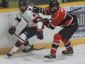 Stratford’s Ethan Martin tries to evade the checking of Listowel’s Caleb Meyer during the second period of Friday’s GOJHL game at Allman Arena. Stratford won 2-1.