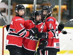Seth Huygen (8) and Callum McMann (21) of the Mitchell Hawks celebrate Braeden Burdett's first period goal Oct. 16 against the visiting Goderich Flyers in PJHL Pollock division action. Mitchell scored early and often in a 13-1 rout, with Tyson Hall, with four goals, and Evan Dowd, with three, leading the attack.