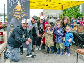 STREET PARTY: Hudson, Mikaela and Lucy pose with Soo Greyhound mascot, Dash and his friends at the Downtown Association's block party prior to the Soo Greyhound's season opening game. This year also sees a return to Moonlight Magic and the annual tree lighting ceremony in front of the courthouse. BOB DAVIES/FOR SAULT THIS WEEK