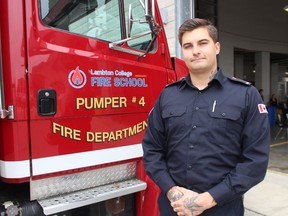 Trayce Shaw stands next to a fire truck at the Lambton College Fire School. He is one of two recipients of the newly created Rick Fraser Memorial Fire Science Award at Lambton College.