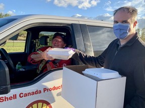 Brad Humble picks up his breakfast from Daniel Walton, both Shell employees, as part of the United Way Shell Canada Employee Kickoff. Shell Sarnia Manufacturing Centre in Corunna represents the third largest employee campaign in Sarnia-Lambton and matches all employee and retiree contributions. United Way photo
