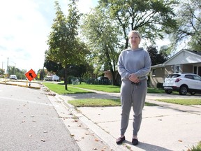 Marnie Mackenzie stands by the edge of Indian Road, north of Errol Road, where a temporary bump-out outlined with yellow, concrete blocks has been in front of her home for two years. (Tyler Kula, The Observer)