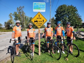 Signs reminding cyclists and motorists to share the road are going up on popular cycling routes in Lambton. Jeff Burchill, left, Kathy Johnson, Ken MacAlpine, Paul Eastman and Pete Cobb with the  Bluewater International Granfondo pose by one of the recently installed signs on Blackwell Side Road. (Submitted)