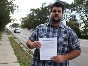 Dave Mueller of Camlachie stands at the Murphy Road overpass in Sarnia near where his wife Laura's vehicle was hit Sunday by a metal pipe while she was driving on Highway 402. Mueller says he wants something done to better protect drivers. He was distributing letters Wednesday asking for anyone with information to contact police. (Tyler Kula/Postmedia Network)