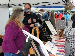 Sheryl Stafford speaks to a customer during the Lambton Central Petrolia Optimist Club's craft and gift show on Saturday October 23, 2021 in Petrolia, Ont. Terry Bridge/Sarnia Observer/Postmedia Network