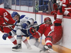Landon McCallum, left, of the Sudbury Wolves, upends Robert Calisti, of the Soo Greyhounds, during OHL exhibition action at the Sudbury Community Arena in Sudbury, Ont. on Friday October 1, 2021. John Lappa/Sudbury Star/Postmedia Network