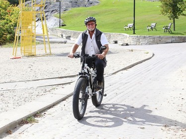 Steven Dagenais rides his e-bike through Bell Park on Tuesday.