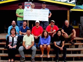 John Island Camp manager Aspen Groom (top left) accepts a $12,500 cheque from Rotary Club president Joanne Bowers and past-president Rick Mackenzie.