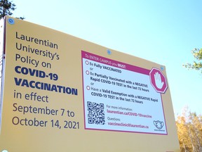 A sign posted at the main entrance to Laurentian University in Sudbury, Ont. outlines Laurentian's COVID-19 vaccination policy. John Lappa/Sudbury Star/Postmedia Network