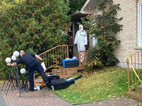 Greater Sudbury Police officers collect forensic evidence Tuesday at the scene of a Bruce Avenue homicide. A man, 40, was found dead Monday night from apparent gunshot wounds inside a residential unit at the Lighthouse co-op.